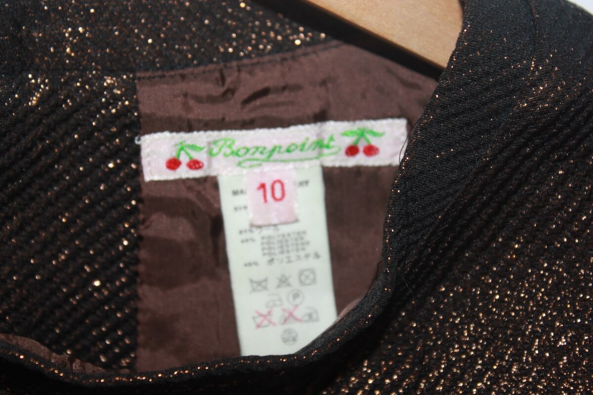 Tweedehands koperkleurige feestelijke jurk met glitters en korte mouwen van bonpoint in maat 134