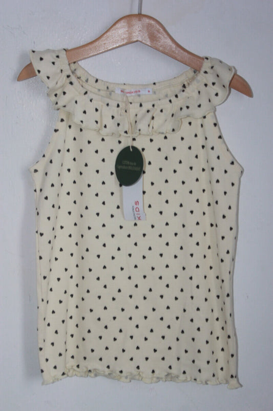 tweedehands creme mouwloze top met zwarte hartjes en een volant in maat 128 van monoprix. 100% bio-katoen